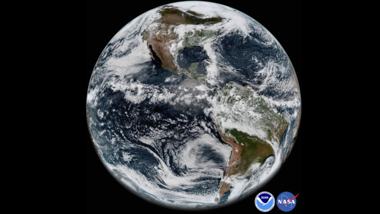 FILE - This image provided by NOAA/NASA In This May 31, 2018 satellite image shows the Earth&#039;s western hemisphere at 12:00 p.m. EDT on May 20, 2018, made by the new GOES-17 satellite, using the Advanced Baseline Imager (ABI) instrument. For the first time in history, world timekeepers may have to consider subtracting a second from our clocks in a few years because the planet is rotating a tad faster.