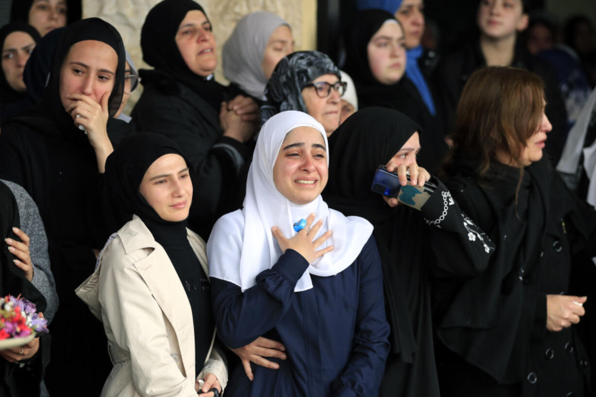 Women mourn during the funeral procession of paramedics who were killed in an Israeli airstrike, in Hebbariye village, south Lebanon, Wednesday, March 27, 2024. The Israeli airstrike on a paramedic center linked to a Lebanese Sunni Muslim group killed several people of its members. The strike was one of the deadliest single attacks since violence erupted along the Lebanon-Israel border more than five months ago.