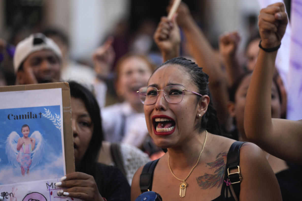 A woman chants the Spanish word for &ldquo;justice&rdquo; during a demonstration protesting the kidnapping and killing of an 8-year-old girl, in the main square of Taxco, Mexico, Thursday, March 28, 2024. Hours earlier a mob beat a woman to death because she was suspected of kidnapping and killing the young girl.