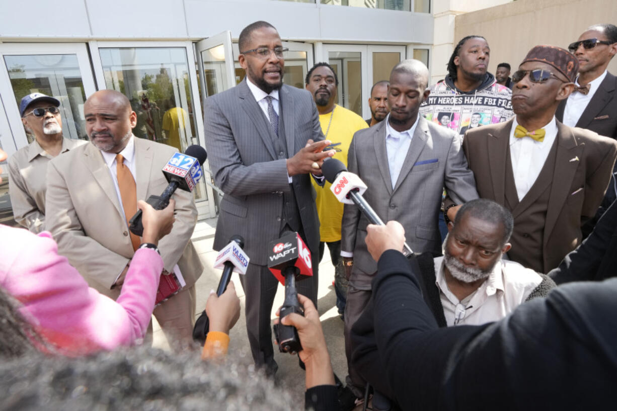 Civil lead counsel Malik Shabazz, center, speaks to reporters following the sentencing of the fourth former Rankin County law enforcement officer, while his client Michael Corey Jenkins, right, listens while outside the federal courthouse in Jackson, Miss., Wednesday, March 20, 2024. Christian Dedmon was sentenced for his part in the racist torture of Parker and Michael Corey Jenkins by a group of white officers who called themselves the &ldquo;Goon Squad&rdquo;. AP Photo/Rogelio V.