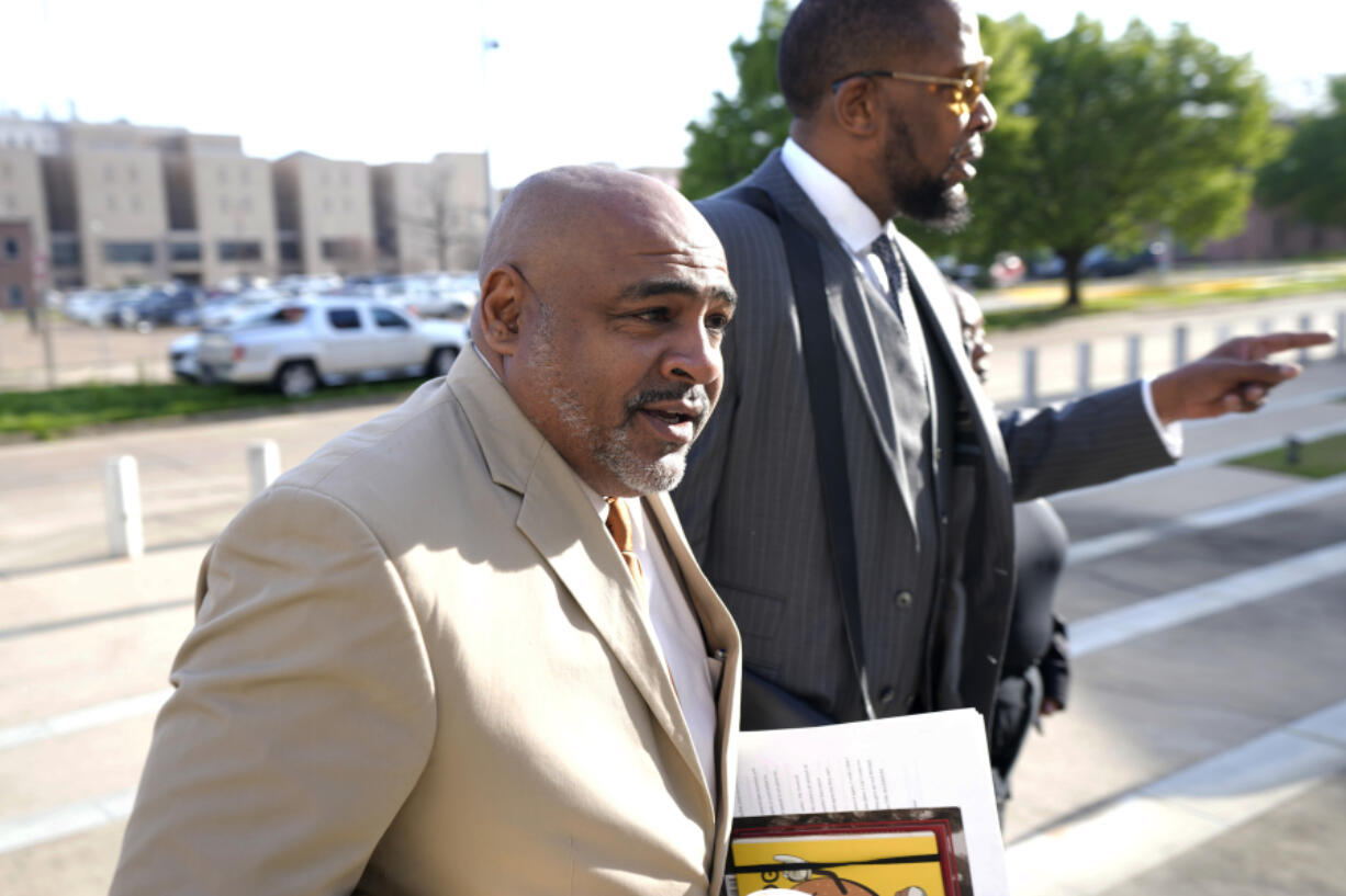 Civil co-counsels Trent Walker, left, and Malik Shabazz for Michael Corey Jenkins and Eddie Terrell Parker, walk towards the Thad Cochran United States Courthouse in Jackson, Miss., Wednesday, March 20, 2024, for sentencing on the third of the six former Mississippi Rankin County law enforcement officers who committed numerous acts of racially motivated, violent torture on Jenkins and Parker in 2023. The six former law officers pleaded guilty to a number of federal charges for torturing them and sentencing began Tuesday in federal court. (AP Photo/Rogelio V.