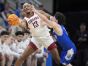 Washington State&rsquo;s Isaac Jones (13) passes around Drake&rsquo;s Conor Enright during the second half of a first-round college basketball game in the NCAA Tournament Thursday, March 21, 2024, in Omaha, Neb.