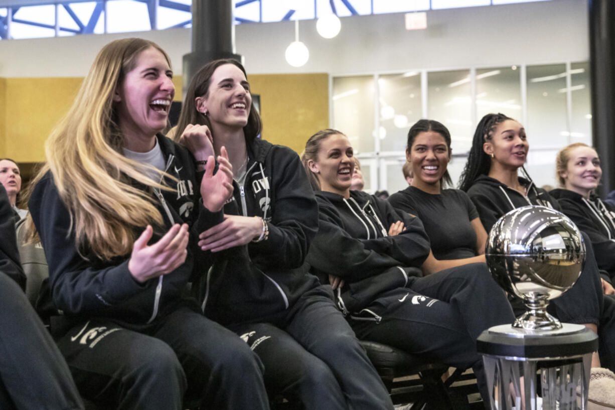 Iowa&rsquo;s Caitlin Clark, center left, and Kate Martin, left celebrate their team&rsquo;s number one seed during an NCAA Selection Sunday watch party Sunday in Iowa City, Iowa.