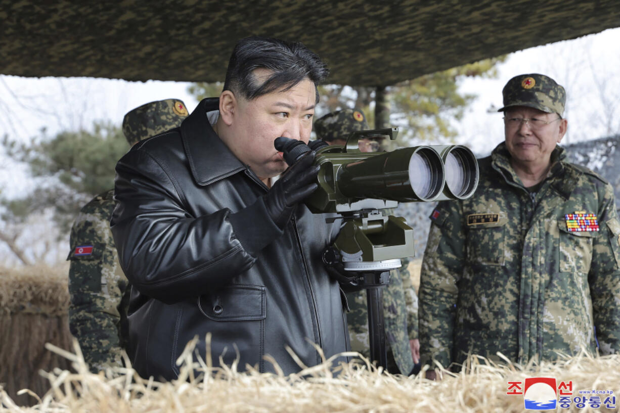 In this photo provided by the North Korean government, North Korean leader Kim Jong Un, left, supervises artillery firing drills in North Korea Thursday, March 7, 2024. Independent journalists were not given access to cover the event depicted in this image distributed by the North Korean government. The content of this image is as provided and cannot be independently verified. Korean language watermark on image as provided by source reads: &quot;KCNA&quot; which is the abbreviation for Korean Central News Agency.