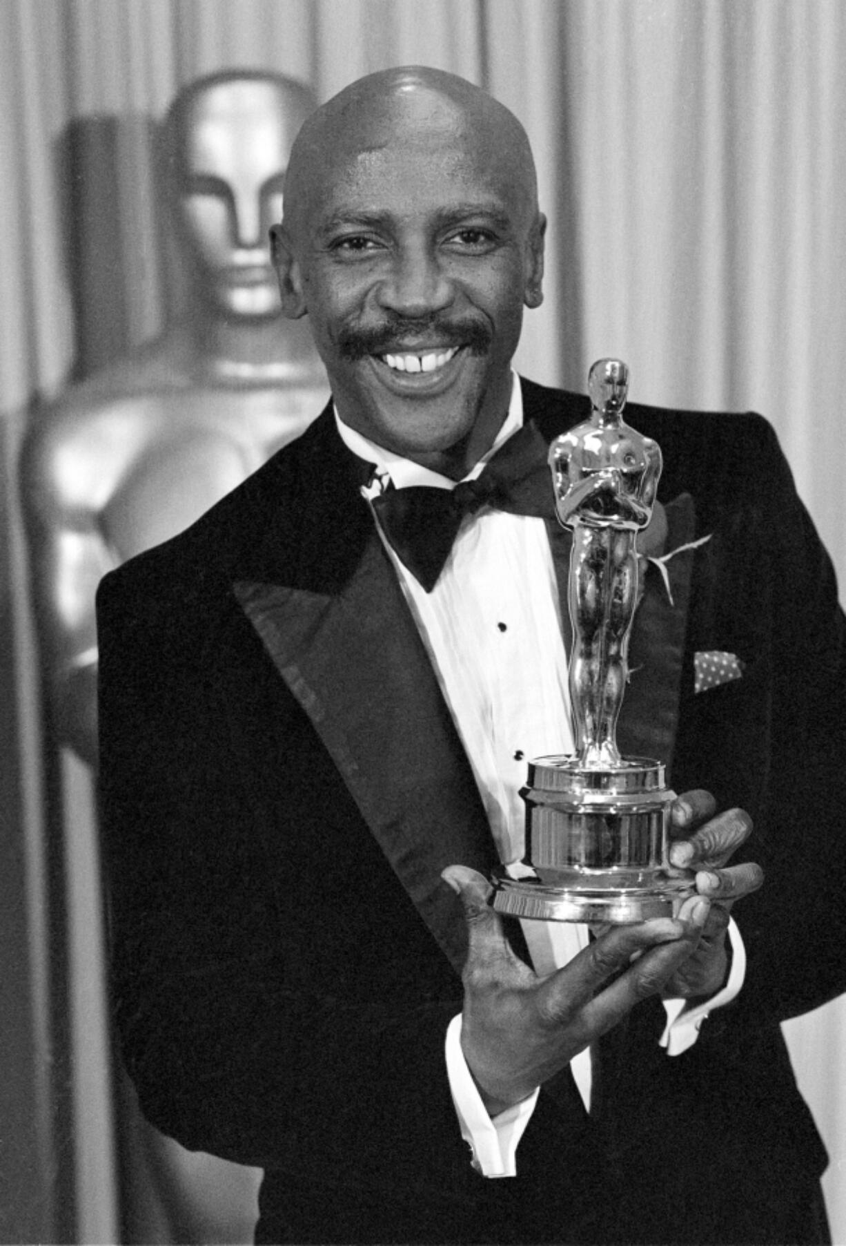FILE - Louis Gossett Jr., poses with the Oscar for best supporting actor for his role in &ldquo;An Officer and a Gentleman,&rdquo; at the annual Academy Awards presentation in Los Angeles on April 11, 1983. Gossett Jr., the first Black man to win a supporting actor Oscar and an Emmy winner for his role in the seminal TV miniseries &ldquo;Roots,&rdquo; has died. He was 87.
