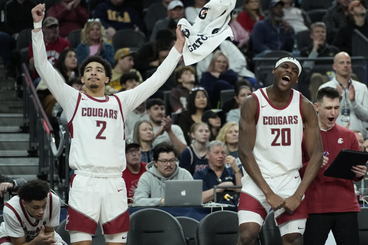 Washington State guard Myles Rice (2) and center Rueben Chinyelu (20) celebrate on the bench as their team defeates Stanford in an NCAA college basketball game in the quarterfinal round of the Pac-12 tournament Thursday, March 14, 2024, in Las Vegas.