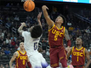 Southern California&#039;s Boogie Ellis (5) fouls Washington&#039;s Koren Johnson (0) during the second half of an NCAA college basketball game in the first round of the Pac-12 tournament Wednesday, March 13, 2024, in Las Vegas.