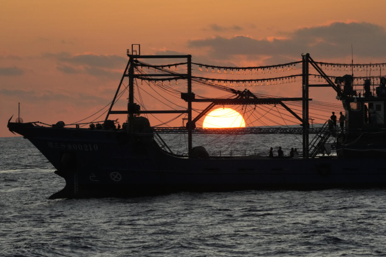 The sun rises while a suspected Chinese militia ship blocks Philippine coast guard ship, not shown, in the disputed South China Sea Tuesday, March 5, 2024. Chinese and Philippine coast guard vessels collided in the disputed South China Sea and four Filipino crew members were injured in high-seas confrontations Tuesday as Southeast Asian leaders gathered for a summit that was expected to touch on Beijing&rsquo;s aggression at sea.