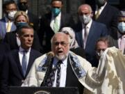 FILE- Rabbi Abraham Cooper, center, of the Simon Wiesenthal Center, speaks in front of civic and faith leaders outside City Hall, Thursday, May 20, 2021, in Los Angeles. A U.S. Congress-mandated group cut short a fact-finding mission to Saudi Arabia over officials in the kingdom ordering a Jewish rabbi to remove his kippah in public, highlighting the religious tensions still present in the wider Middle East.