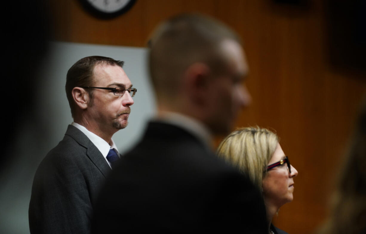 James Crumbley, left, stands with his attorney Mariell Lehman as Oakland County Judge Cheryl Matthews swears in the jury before Crumbley&#039;s trial on Thursday, March. 7, 2024 in Pontiac, Mich.  James Crumbley, 47, is charged with four counts of involuntary manslaughter, one for each teenager killed by Ethan Crumbley at Oxford High School in 2021.