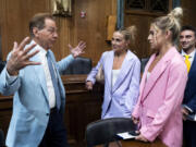 Former University of Alabama Head Football Coach Nick Saban, from left, talks to former University of Miami student athlete Hanna Cavinder and her twin sister TCU student athlete Haley Cavinder, at the conclusion of a roundtable on the future of college athletics and the need to codify name, image and likeness rights for student athletes, on Capitol Hill, Tuesday, March 12, 2024, in Washington.
