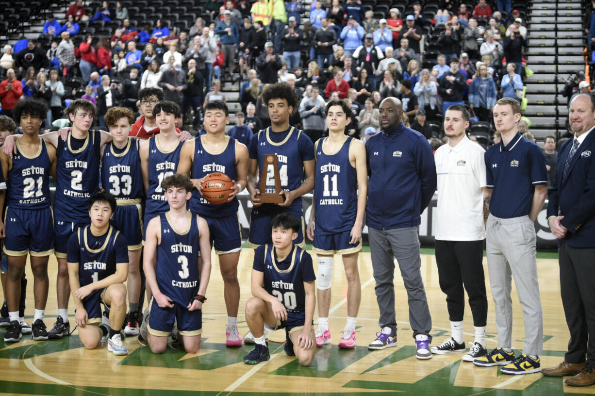 The Seton Catholic boys basketball team poses with the sixth place trophy at the Class 1A state tournament Saturday, March 2, 2024 in Yakima. The Cougars' season ended with a 53-46 loss to Freeman in the fourth-place game.
