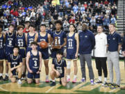 The Seton Catholic boys basketball team poses with the sixth place trophy at the Class 1A state tournament Saturday, March 2, 2024 in Yakima. The Cougars' season ended with a 53-46 loss to Freeman in the fourth-place game.