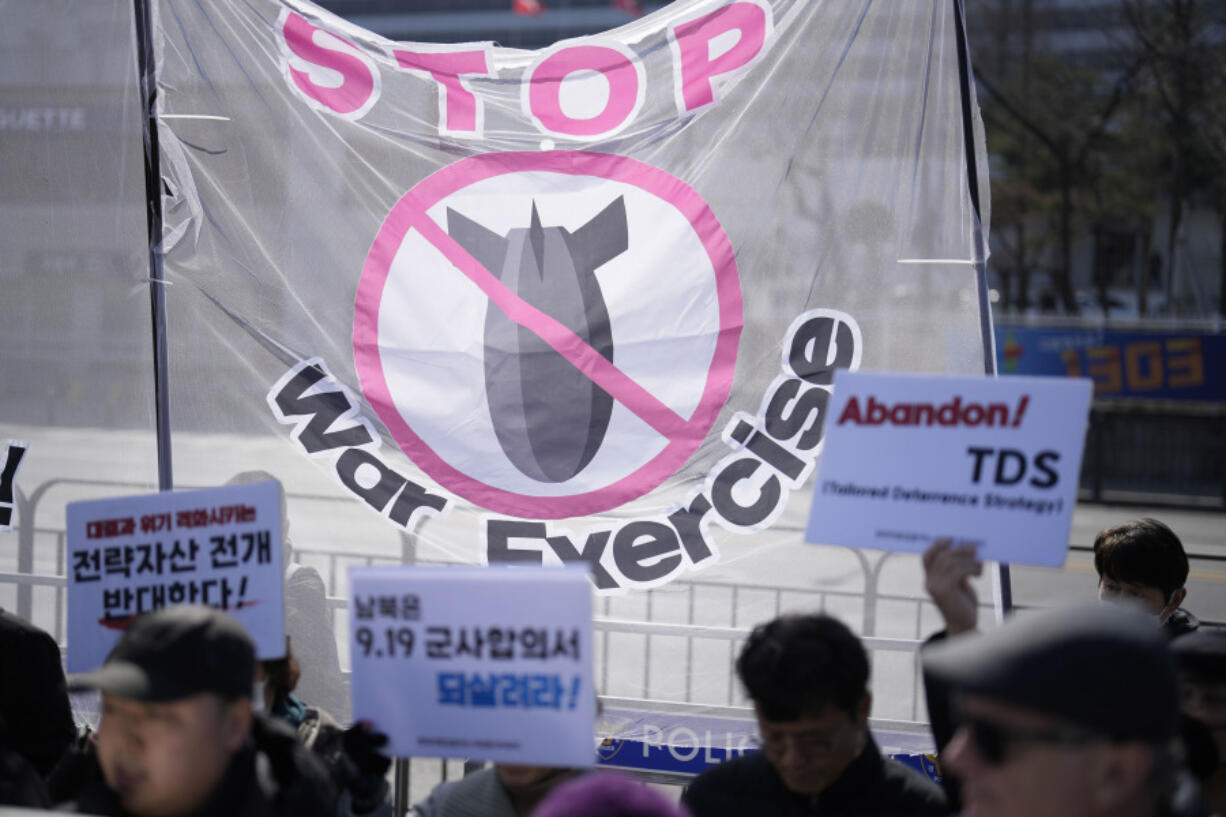 Protesters hold signs during a rally demanding to stop the joint military exercises between the U.S. and South Korea, in Seoul, South Korea, Monday, March 4, 2024. South Korea and the United States began large annual military exercises Monday to bolster their readiness against North Korean nuclear threats after the North raised animosities with an extension of missile tests and belligerent rhetoric earlier this year.