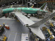 FILE - In this photo taken with a fish-eye lens, a Boeing 737 MAX 8 airplane sits on the assembly line during a brief media tour in Boeing&rsquo;s 737 assembly facility in Renton, Wash., March 27, 2019. Boeing is in talks to buy Spirit AeroSystems, which builds fuselages for Boeing 737 Max jetliners including the one that suffered a door-panel blowout in January, according to a published report, Friday, March 1, 2024. (AP Photo/Ted S.