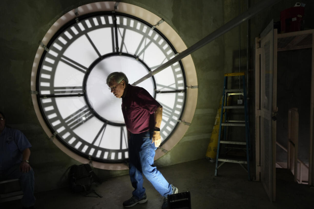 Don Bugh walks inside the historic clock tower atop the Dallas County Courthouse, Thursday, March 7, 2024, in Dallas. The mechanical clock built in 1890 requires hand lubrication and reseting twice a year with daylight savings time.