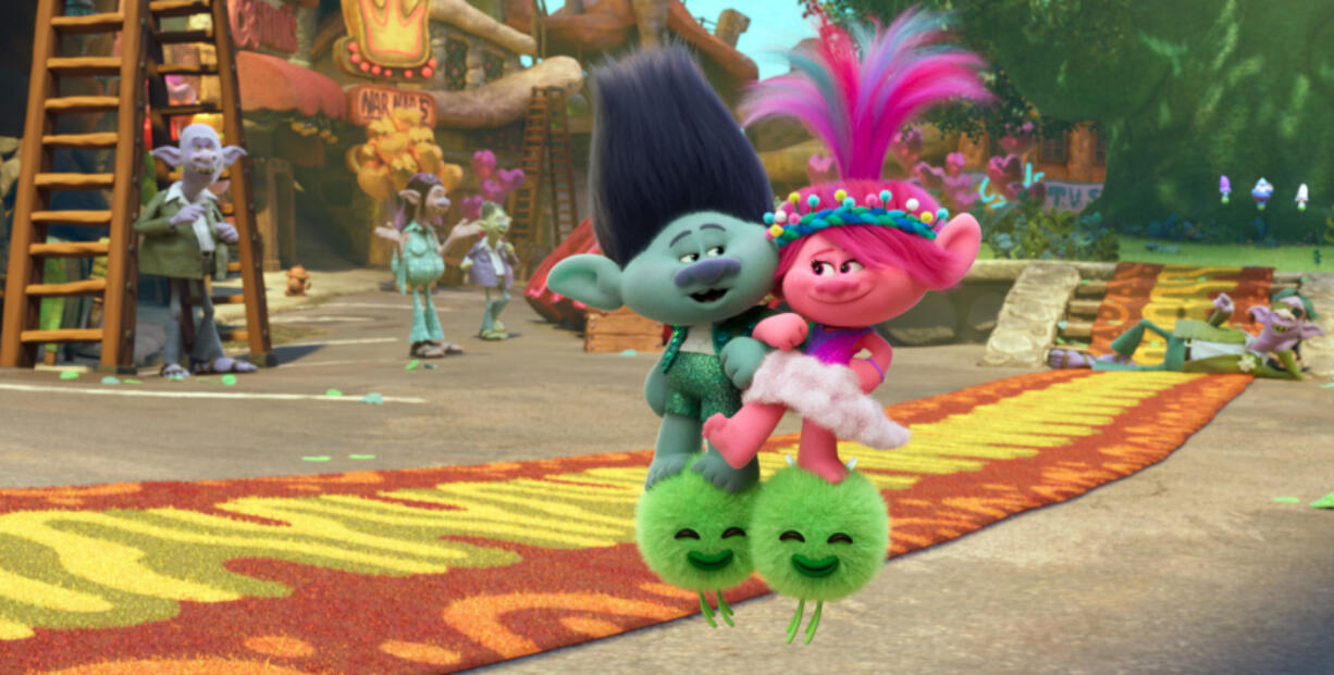 This image released by DreamWorks Animation shows the characters Branch voiced by Justin Timberlake, center left, and Queen Poppy voiced by Anna Kendrick, center right, in a scene of the animated film &ldquo;Trolls Band Together.&rdquo; (DreamWorks Animation via AP)