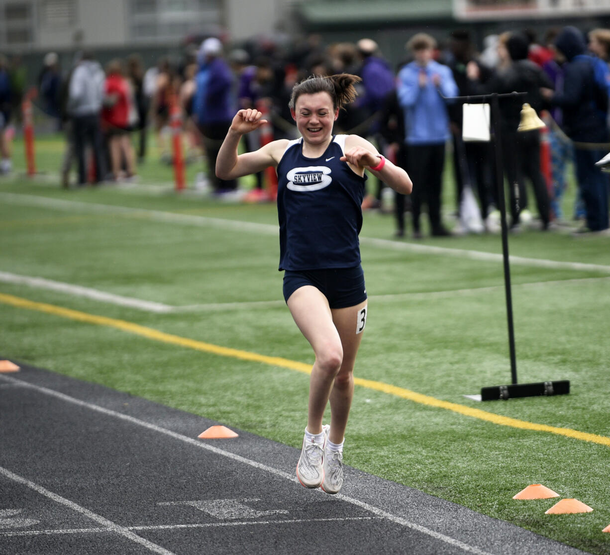 Daphne Evenson of Skyview celebrates as she crosses the finish of the girls 1,600 meters at the Tiger Invite at Battle Ground High School on Saturday, March 23, 2024.