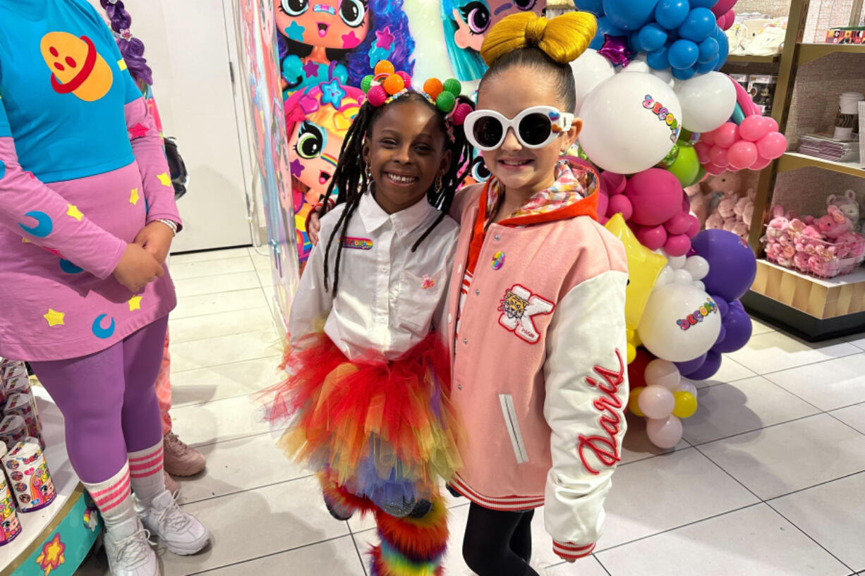 Taylen Biggs, right, and Nubia Williams pose at an FAO Schwarz store where toy company Cepia LLC launched its new fashion doll line called Decora Girlz on March 2, 2024 in New York. Cepia, which is based in St. Louis, Missouri, began investing in TikTok in 2019.