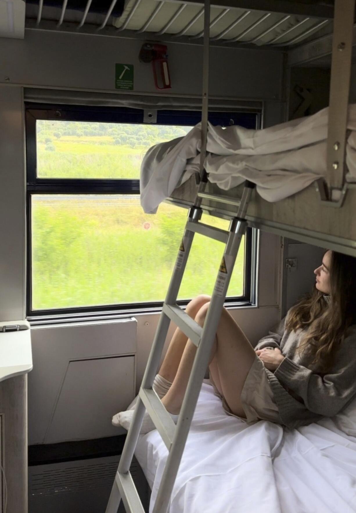 Sarah Marks of London looks out at the Italian countryside June 10 on TrenItalia&rsquo;s Intercity Notte sleeper train from Palermo to Rome.