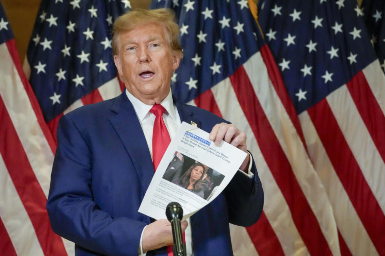 FILE - Former President Donald Trump holds up a copy of a story featuring New York Attorney General Letitia James while speaking during a news conference, Jan. 11, 2024, in New York. Trump could find out Monday, March 25, how New York state aims to collect over $457 million he owes in his civil business fraud case, even as he appeals the verdict that led to the gargantuan debt.