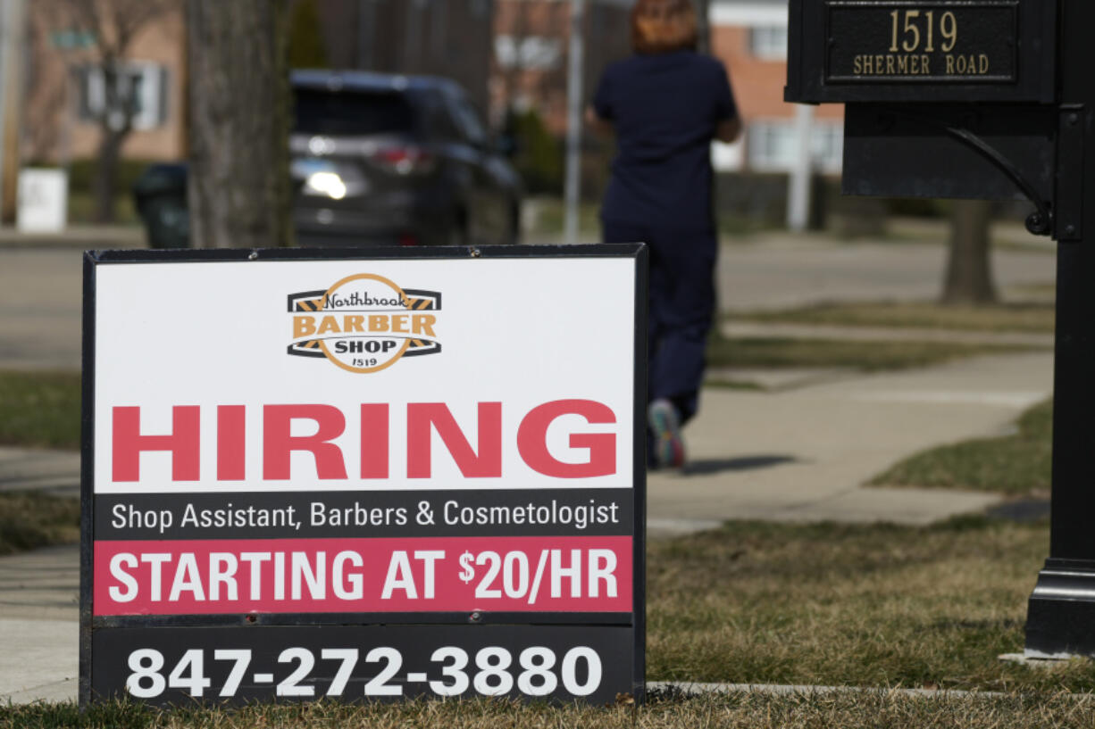 A hiring sign is seen outside of a barber shop in Northbrook, Ill., Tuesday, March 12, 2024. On Thursday, March 28, 2024, the Labor Department issues the latest weekly report on first-time applications for unemployment benefits. (AP Photo/Nam Y.