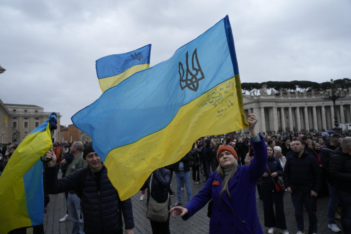 People waves Ukrainian flags before Pope Francis Angelus noon prayer from the window of his studio overlooking St.Peter&#039;s Square, at the Vatican, Sunday, March 10, 2024.