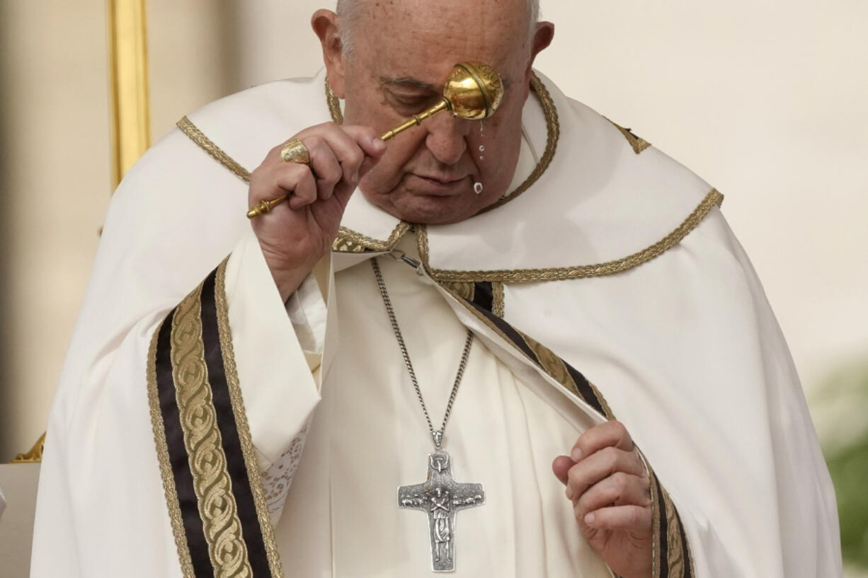 Pope Francis asperses holy water as he celebrates Easter mass in St. Peter&#039;s Square at the Vatican, Sunday, March 31, 2024.