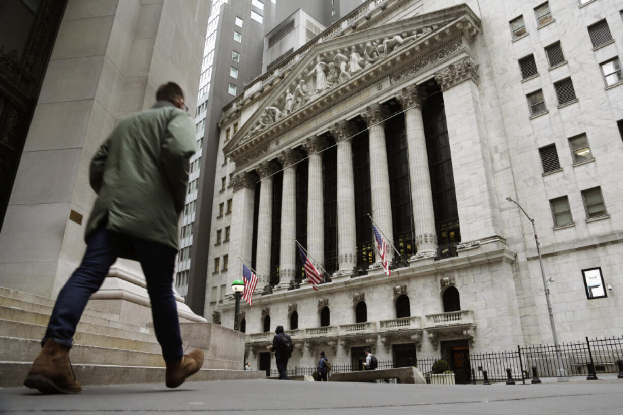 FILE &mdash; People pass the front of the New York Stock Exchange, March 22, 2023. The average Wall Street bonus fell slightly last year to $176,500 as firms took a &ldquo;more cautious approach&rdquo; to compensation, New York state&rsquo;s comptroller reported Tuesday, March 19, 2024.