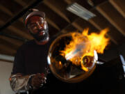 Glassblower Cedric Mitchell at work Feb. 21 in his El Segundo studio in California.