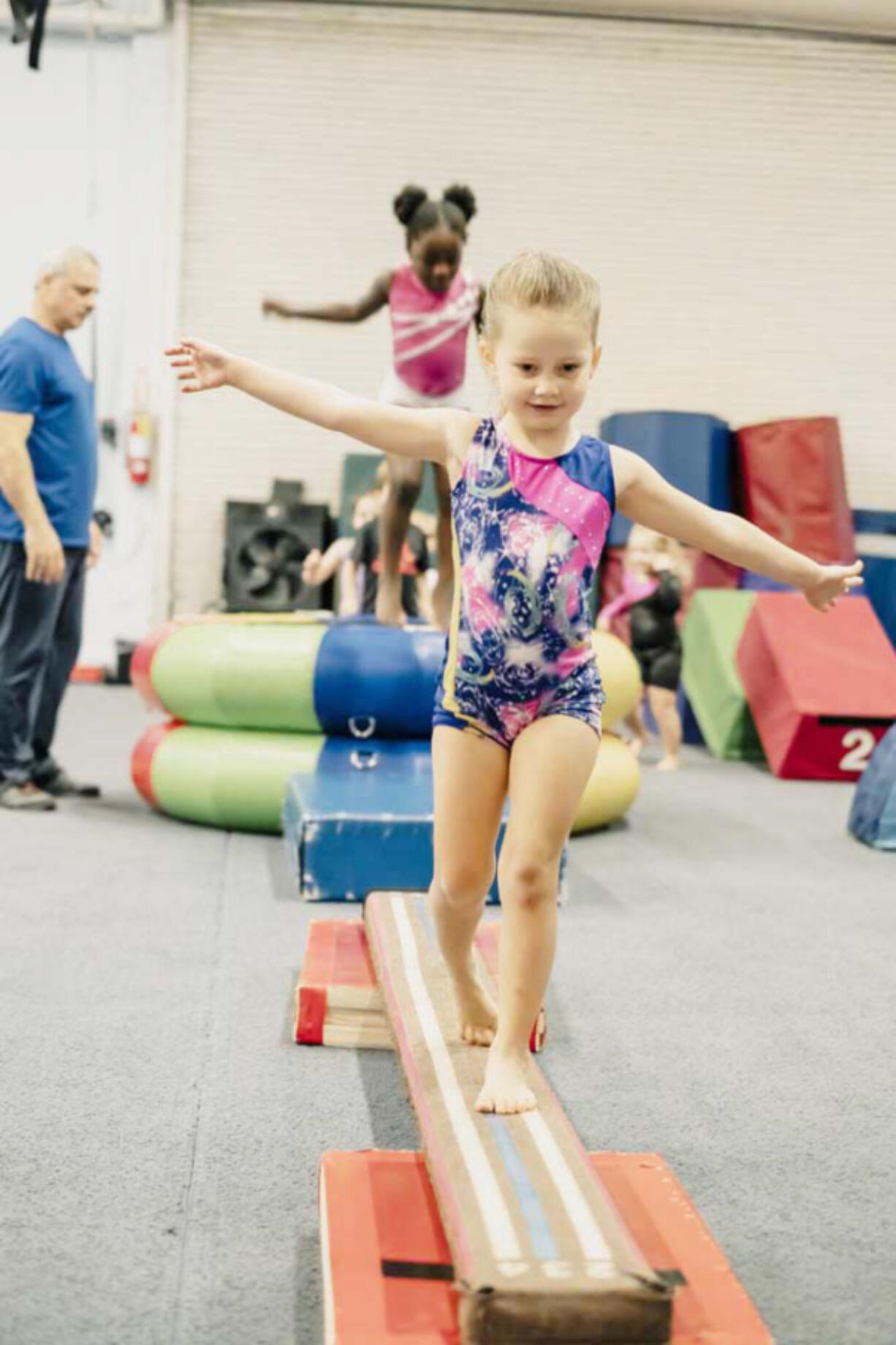 A student walks on a beam during a Vancouver Elite Gymnastics Academy class.