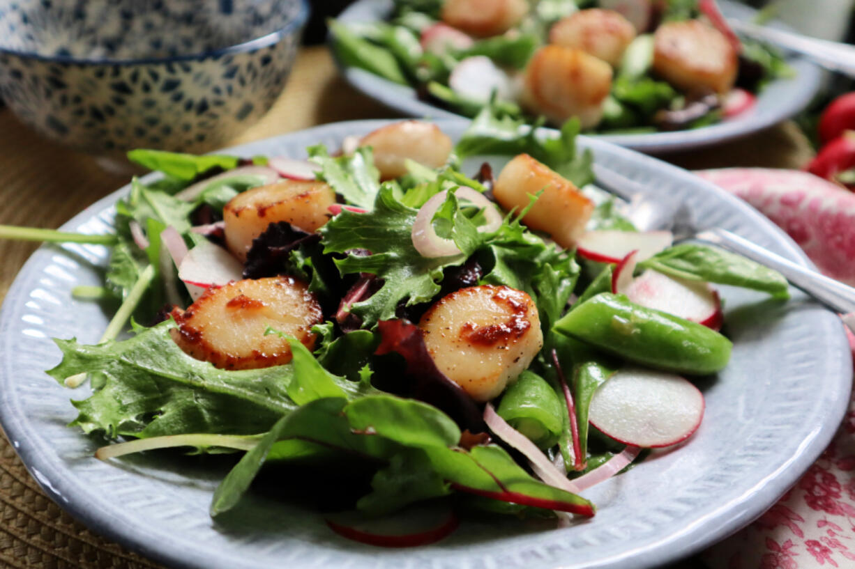 Pan-seared scallops top this seasonal salad with sugar snap peas and fresh radish.
