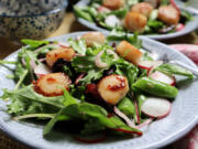 Pan-seared scallops top this seasonal salad with sugar snap peas and fresh radish.