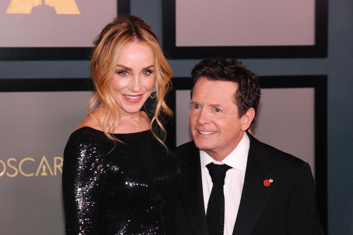 Tracy Pollan, left, and Michael J. Fox walk the red carpet at the Academy of Motion Picture Arts and Sciences 13th Governors Awards at the Fairmont Century Plaza on Nov. 19, 2022, in Los Angeles.