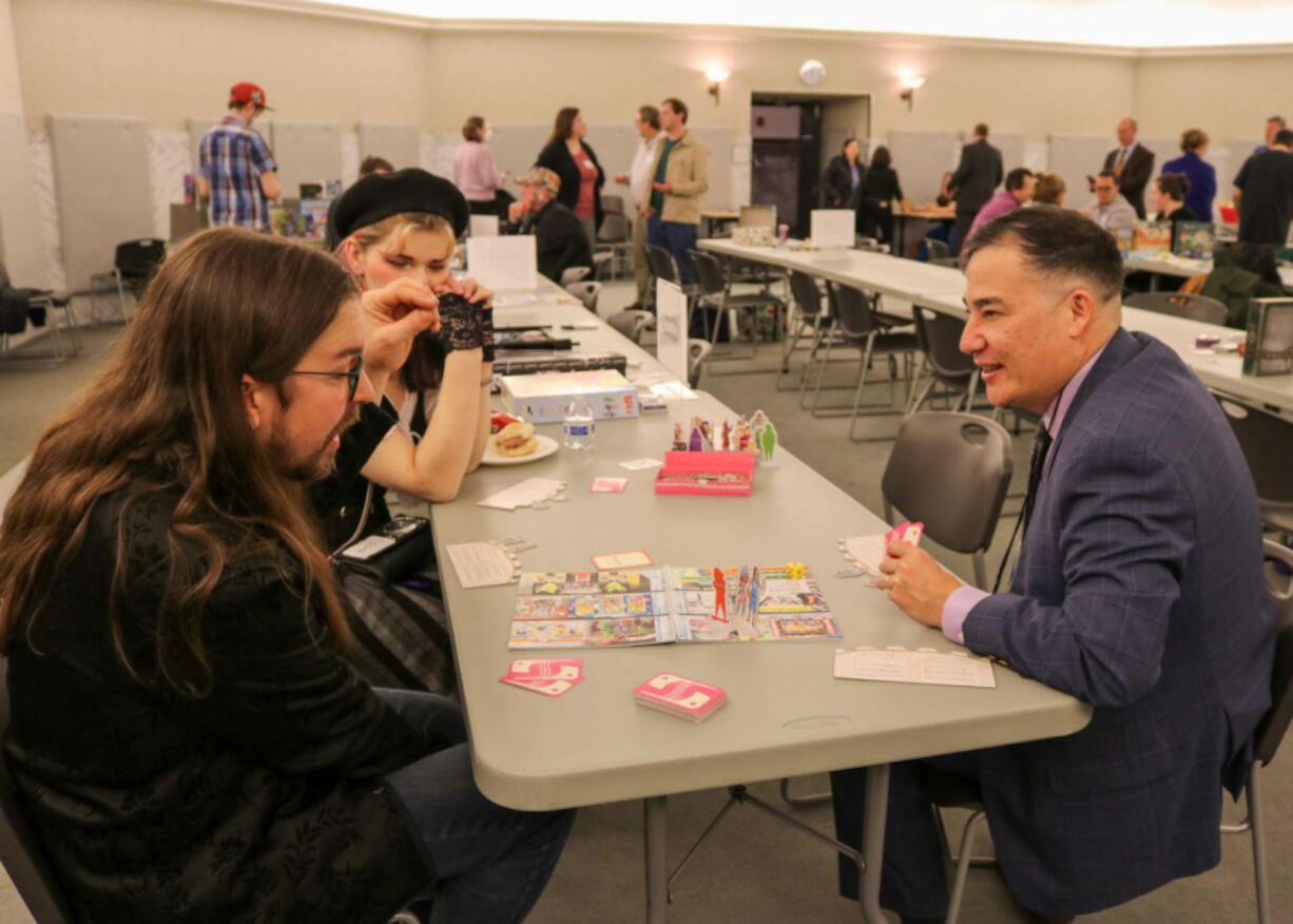 Washington Secretary of State Steve Hobbs, right, seen here at a game night event in February 2024, at the state Capitol in Olympia, will travel to Japan on a trip to promote economic ties between the country and Washington state, including in the tabletop gaming sector.