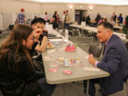 Washington Secretary of State Steve Hobbs, right, seen here at a game night event in February 2024, at the state Capitol in Olympia, will travel to Japan on a trip to promote economic ties between the country and Washington state, including in the tabletop gaming sector.