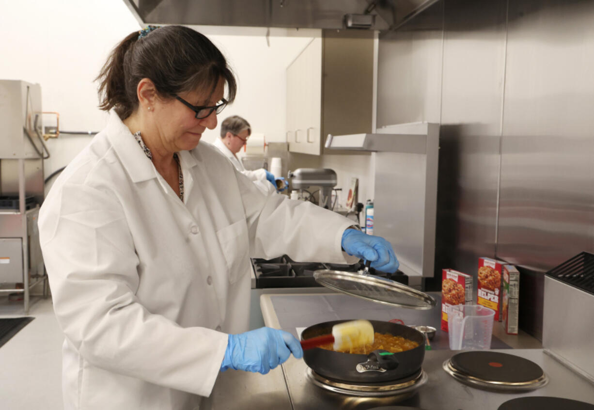 Senior scientist Lisa Humphrey cooks up a batch of Hamburger Helper on March 7 inside of a test kitchen at Eagle Foods Innovation Hub in Buffalo Grove, Ill.