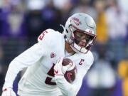 Washington State wide receiver Lincoln Victor (5) carries the ball against Washington during the second half of an NCAA college football game Saturday, Nov. 25, 2023, in Seattle. Washington won 24-21.