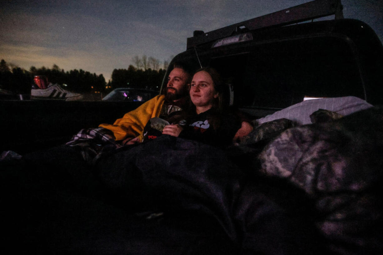 Sitting in the back of a pickup truck, Dustin Roberts and Ashlyn Rimsky from Walnutport watch &ldquo;Leprechaun&rdquo; at Shankweiler&rsquo;s Drive-In, near Allentown, in Orefield, Pennsylvania, on Friday, March 15, 2024. On April 13, the drive-in will celebrate its 90th anniversary. (Steven M. Falk/The Philadelphia Inquirer/TNS) (Steven M.