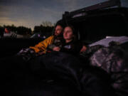 Sitting in the back of a pickup truck, Dustin Roberts and Ashlyn Rimsky from Walnutport watch &ldquo;Leprechaun&rdquo; at Shankweiler&rsquo;s Drive-In, near Allentown, in Orefield, Pennsylvania, on Friday, March 15, 2024. On April 13, the drive-in will celebrate its 90th anniversary. (Steven M. Falk/The Philadelphia Inquirer/TNS) (Steven M.