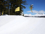 A skier floats over the Central Oregon Cascades while launching a 360 in the Woodward Terrain Park near the Skyliner lift at Mt. Bachelor.