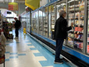 A customer shops for food at a grocery store on March 12, 2024, in San Rafael, California.