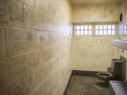 Graffiti covers the walls of a jail cell at the Clark County Jail.