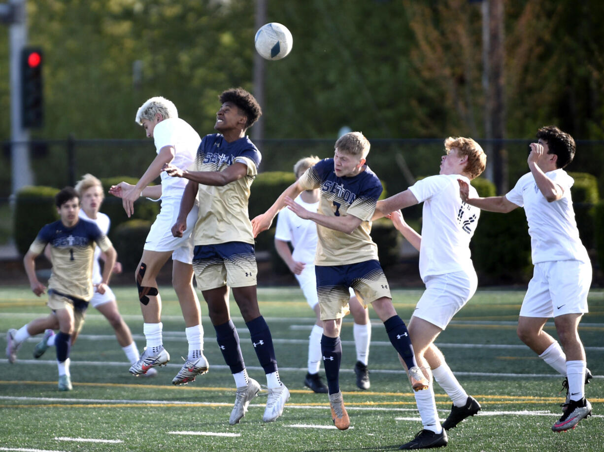 Seton Catholic's Derebe Smith (8) goes up for the ball against King's Way Christian's Leif Evenson, left, during a Trico League boys soccer match on Tuesday, April 16, 2024, at Seton Catholic High School.