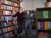Lauren Richards, left, and Caitlin O&rsquo;Neil, co-owners of romance bookstore Tropes &amp; Trifles, pose for portrait inside their bookstore in Minneapolis, Minn., on April 4.