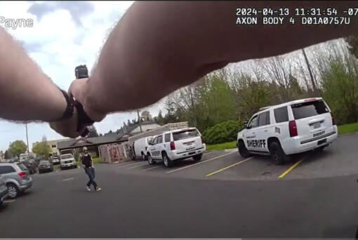 A screenshot from body-worn camera footage in a shooting in Salmon Creek shows Clark County sheriff’s Deputy Jim Payne pointing a weapon at a suspect in carjackings. The suspect pulled a weapon from his pocket.
