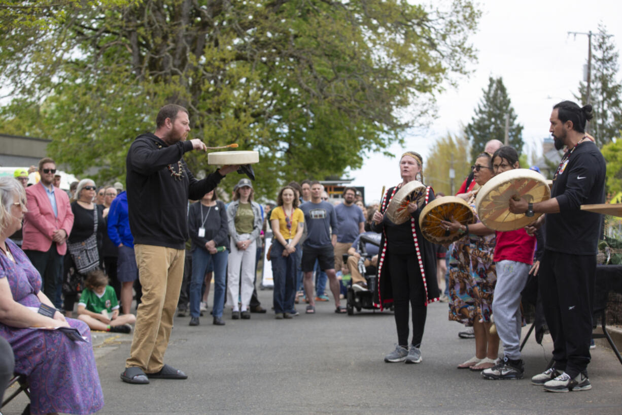 The Cowlitz Indian Tribe Drum Group, led by Jeremiah Wallace, center left, performs at the April 20 installation of a new Indigenous Grandmother Camus statue.