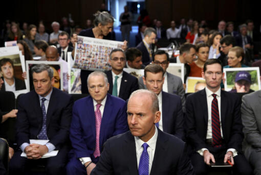 Dennis Muilenburg, former president and CEO of the Boeing Company, sits at the witness table in front of family members of those who died aboard Ethiopian Airlines Flight 302 while waiting for the start of hearing held by the Senate Commerce Committee Oct. 29, 2019, in Washington, D.C.