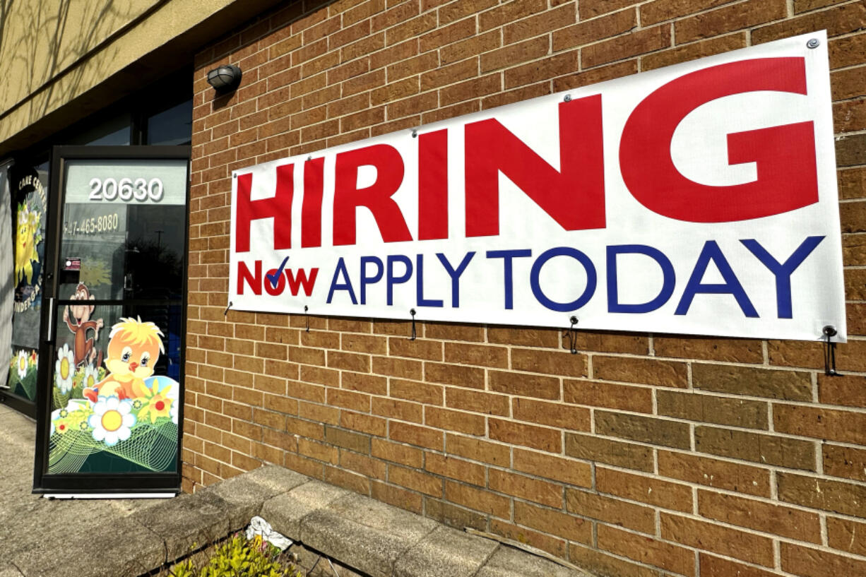 A hiring sign is displayed in Riverwoods, Ill., on April 16. The Biden administration has finalized a new rule set to make millions of more salaried workers eligible for overtime pay in the U.S. The move marks the largest expansion in federal overtime eligibility seen in decades.