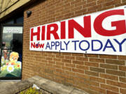 A hiring sign is displayed in Riverwoods, Ill., on April 16. The Biden administration has finalized a new rule set to make millions of more salaried workers eligible for overtime pay in the U.S. The move marks the largest expansion in federal overtime eligibility seen in decades.